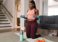 A black woman lifting dumbbells